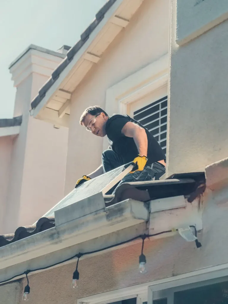 a man checking a solar panel
